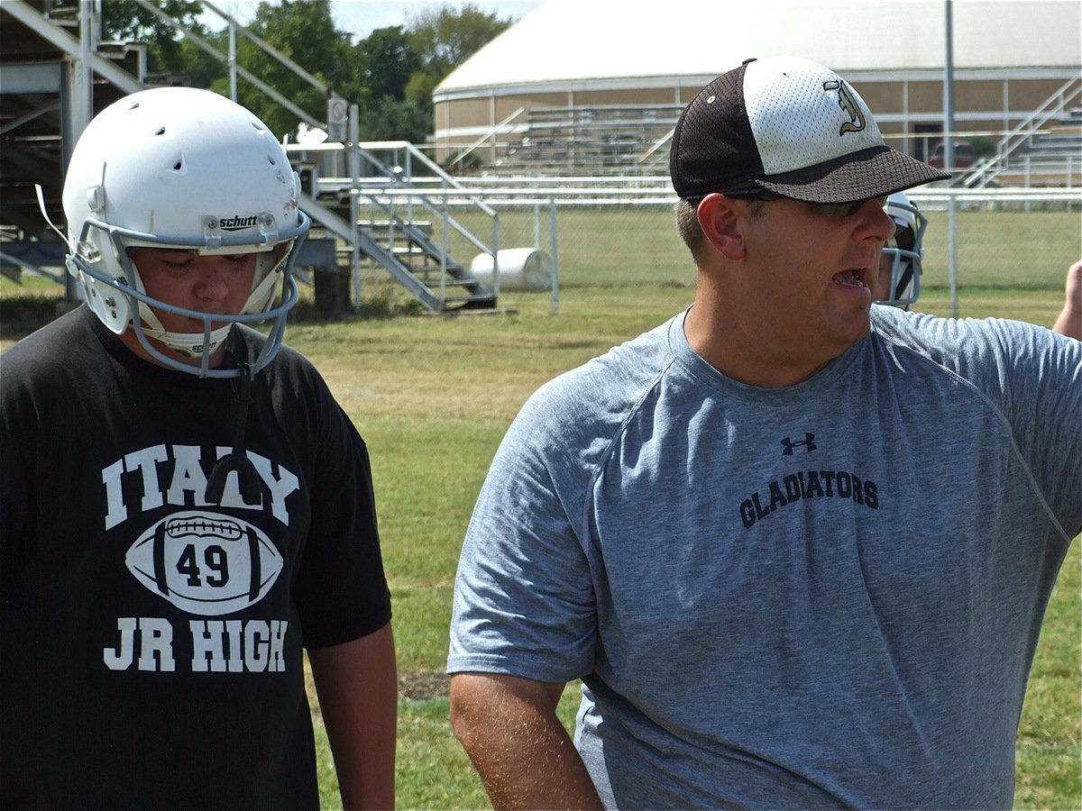 Image: FUNdamentals — Coach Matt Coker emphasizes the fundamentals as Kevin Roldan prepares to execute the block.