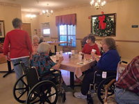 Image: Birthday Fun — These residents are celebrating December birthdays with cake, ice cream and punch.
