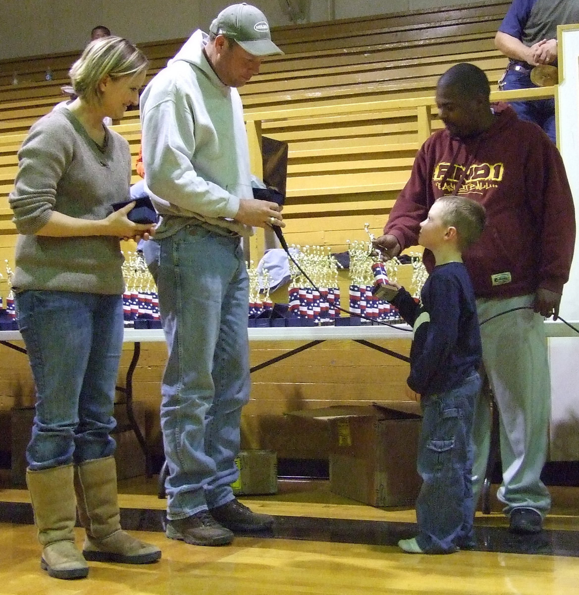 Image: IYAA Recognition Program — Bryce DeBorde literally looks up to his coaches for guidance and instruction this basketball season.  It’s all worth it when you see his face light up when he gets his trophy.