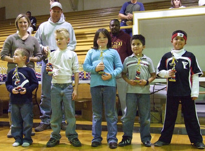 Image: Rogers’s Lil’ Rascals — Coach Scot Rogers’ troops line up and display their trophies.