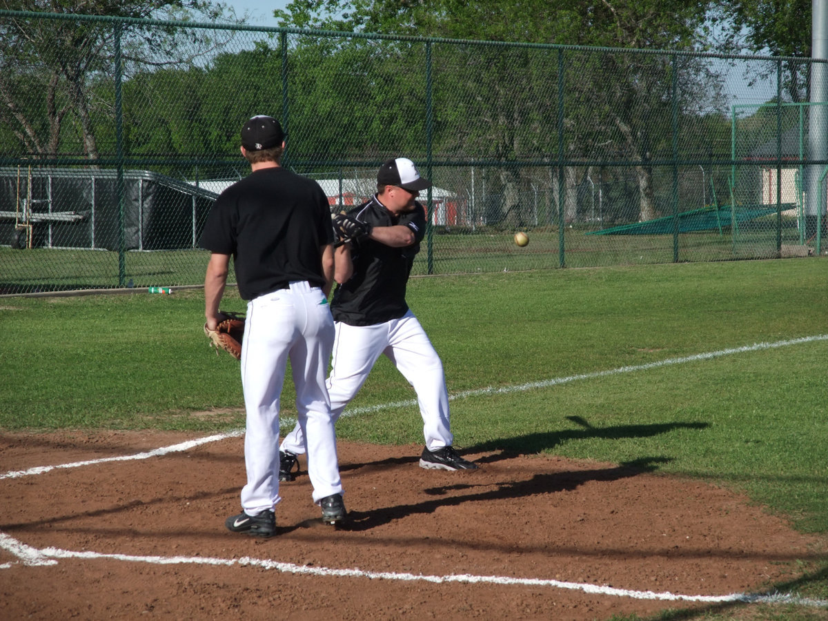 Image: Warming up the players — Coach Ward hits a few to his defense before Italy’s game against Grand Prairie AA.