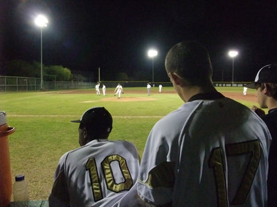 Image: The dugout view — Jasenio Anderson #10 and Brandon Souder #17 watch the game through winning eyes.