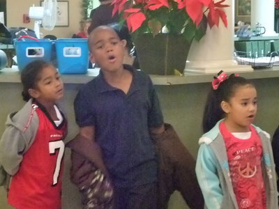 Image: Caught up in song — These students were very serious about Rudolph.