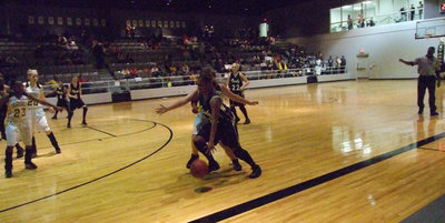 Image: Shay Fleming — Fleming comes down the court to score two more points for the Lady Gladiators.