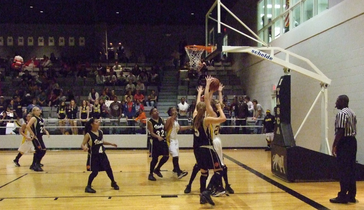 Image: Going for it — Italy’s defense goes for a much needed rebound against Itasca.