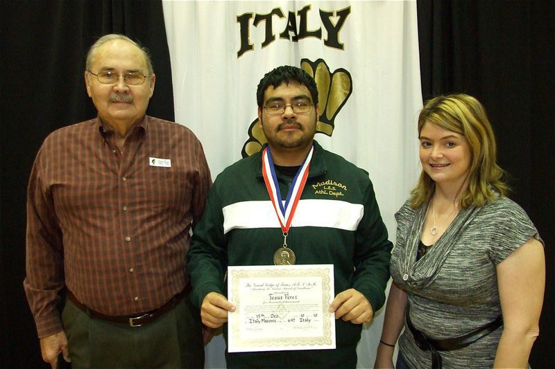 Image: Mason’s recognize excellence and honor IHS band director Jesus Perez — Mr. Fred Ivy and Italy High School Principal Tanya Parker stand alongside IHS band director Jesus Perez as he displays his Mirabeau B. Lamar Award for Excellence in Education certificate and medal which was bestowed to Perez by the Italy Masonic Lodge #647.