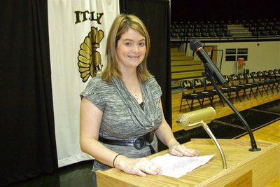 Image: Principal Parker at the podium — Italy High School Principal Tanya Parker calls an early morning assembly on Tuesday to surprise IHS band director Jesus Perez with an award.