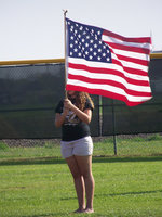 Image: Fortunate to play — Alyssa Richards (8th grader) proudly displays the American Flag during the National Anthem before an Italy Lady Gladiator softball game.