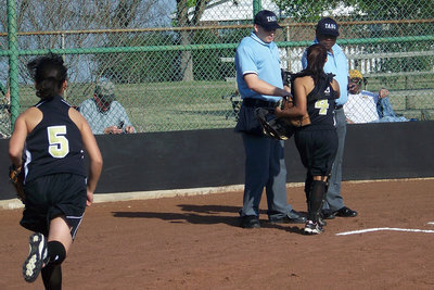Image: Perez and Luna — Marisella Perez #4, Lupita Luna #5 trot over to greet the umpires during pre-game introductions.