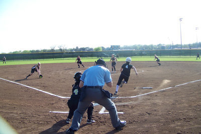 Image: Megan gets a mitt on it — 3rd Baseman, Megan Richards, fields a bunt against the Grandview Lady Zebras.