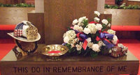 Image: The altar at First Baptist — The flowers are in honor of Todd Bell, fireman, co-worker and friend.