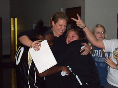 Image: Birthday squeeze — Jimesha Reed and Blanca Figueroa give Coach McDonald a big hug for her birthday.