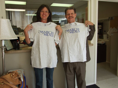 Image: Showing OFF T-Shirts — Terri and Jerry are proud of their shirts.