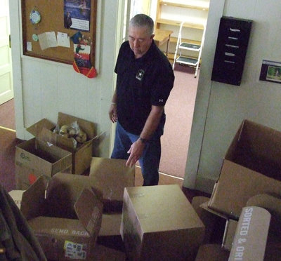 Image: It takes boxes — Sandy Westbrook stacks boxes for the donations and deliveries.