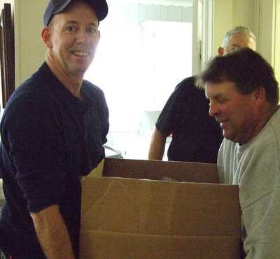 Image: Lift and tote men — Tommy Sutherland and Brian Mathiowetz lend a helping hand during delivery.