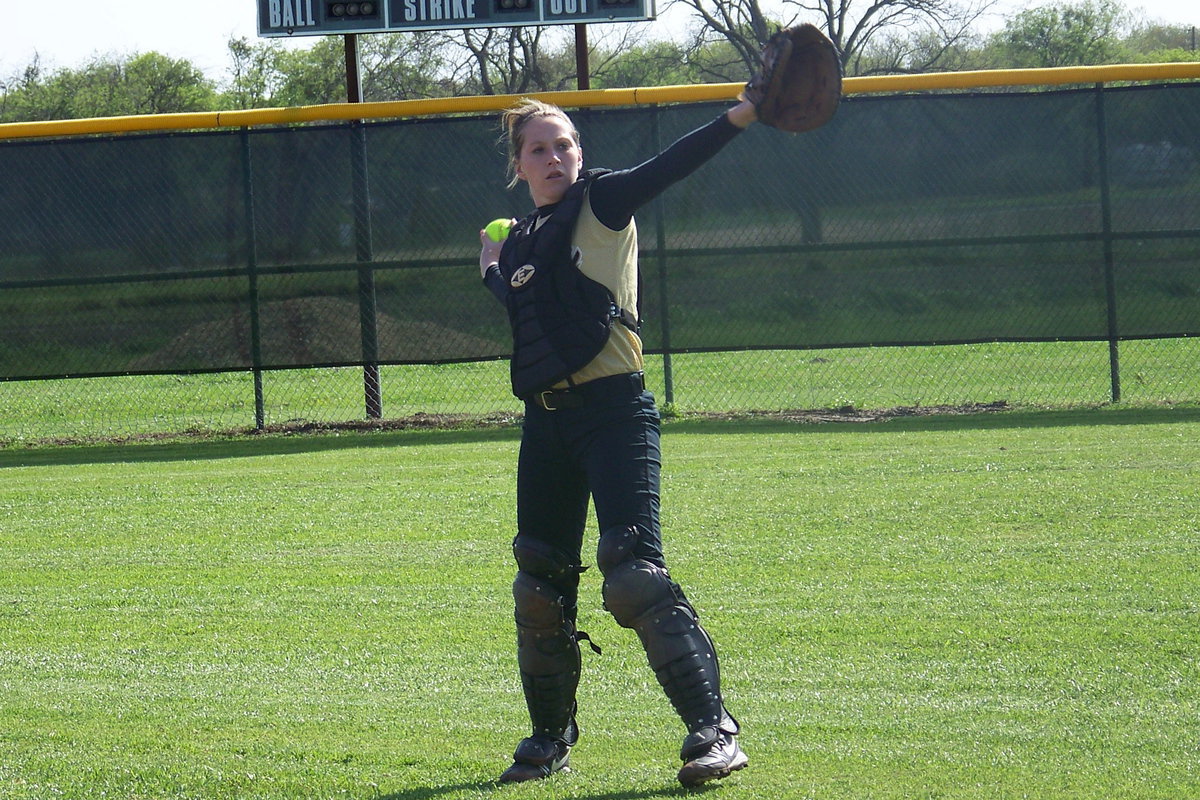 Image: Striking the Lady Gladiator pose — Catcher, Bailey Bumpus warms-up before the game.