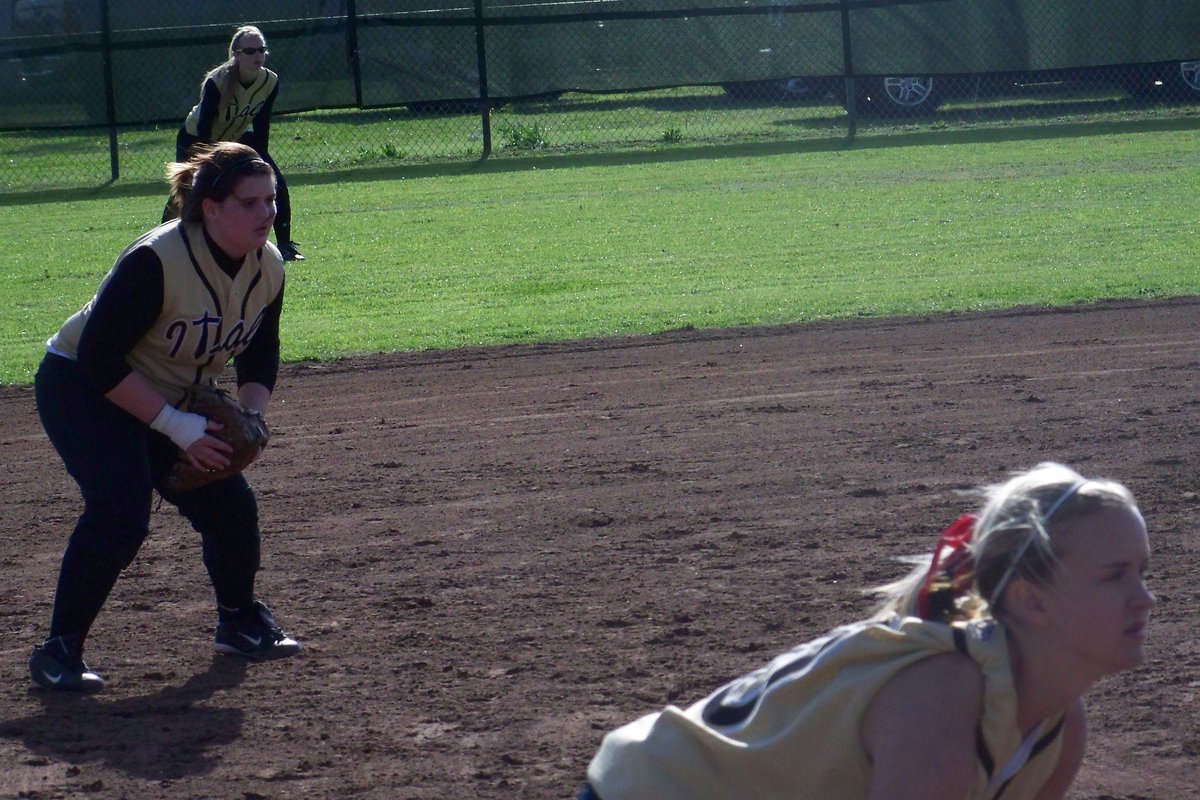 Image: Juniors on a mission — Courtney Westbrook, Meredith Brummett and Abby Griffith are just as focused on making the playoffs as they are on this next pitch.