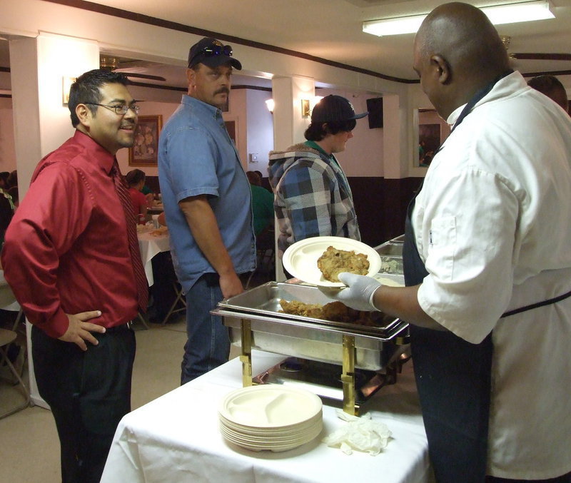 Image: Mr. Perez takes time to eat — The Gladiator Band Booster Club arranged for the band to have a good meal before the competition in Waco.