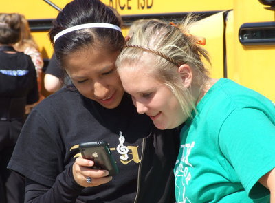 Image: Co-Drum Majors — Drenda and Jessica read one last “good luck” text from their pals at IHS.