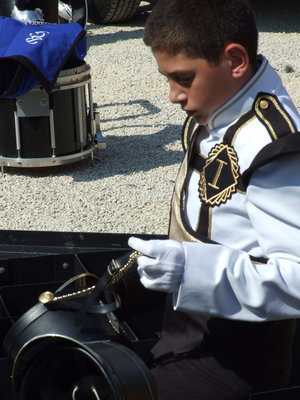 Image: Uniform adjustment — Tristan Oldfield adjusts the buckle on his helmet.