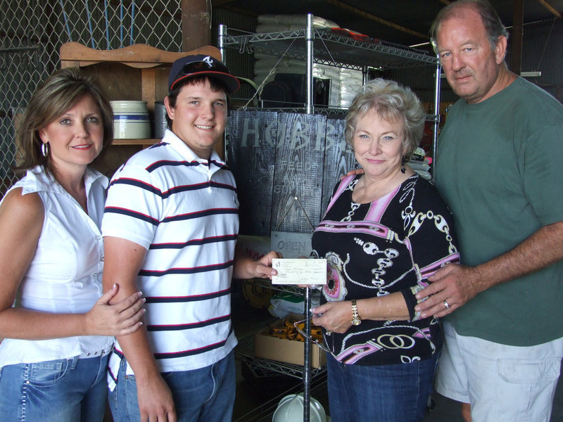 Image: Roy and Hobbs — Roy Glaspy, recent graduate of Italy High School, stands with his mom, Lisa Poarch and Joyce and James Hobbs of Hobbs Feed Store.  Roy is the first recipient of a scholarship from the newest business in town.