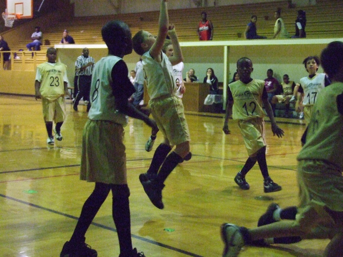 Image: J.T. takes a jumper — Escamilla tries to rally his team.