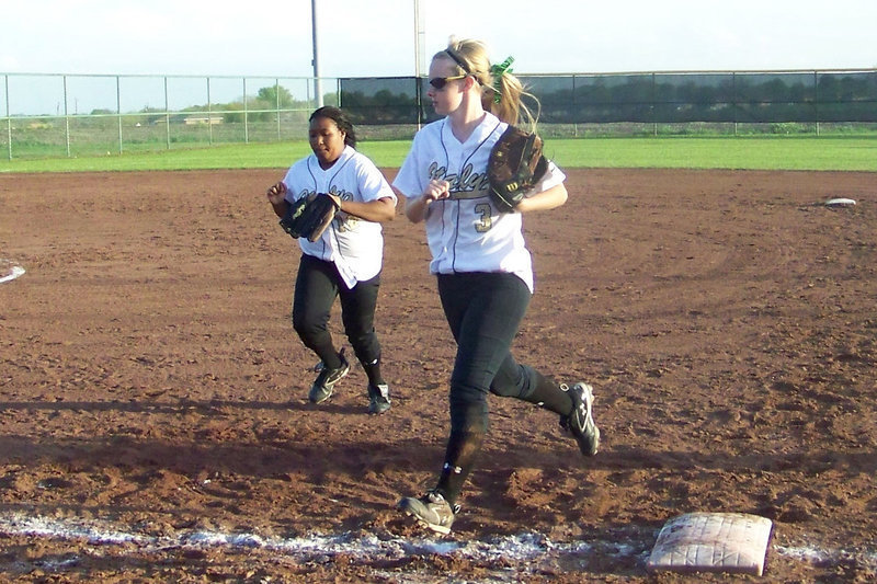 Image: Hustle — Abby Griffith and Khadisha Davis hustle in at the close of the half-inning.