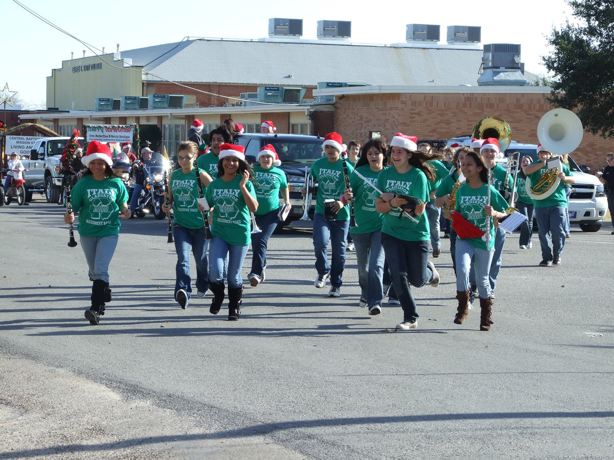 Image: Hurry up — The Italy High School Gladiator Regiment Band hurries into position to walk in the parade.