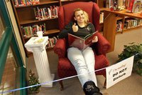Image: Casandra Jeffords participates in the IHS Reading Marathon — Casandra Jeffords enjoys a good book, popcorn and a drink while participating in the Italy High School Reading Marathon.