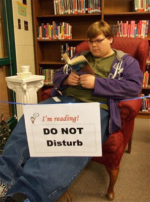 Image: Logan Owens — Logan Owens kicks back inside the “Reading Parlor” which was sectioned off this week inside the Italy High School Library for students and faculty volunteers to each enjoy 30 minutes of uninterrupted reading.