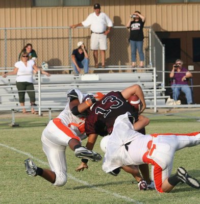 Image: Bulldogging a Bulldog — Two Eagle defenders keep this Bynum runner from busting out.