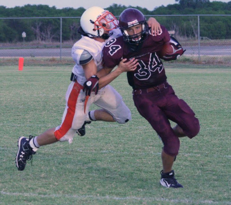 Image: Flying tackle — This Eagle defender is making a flying tackle, of course.