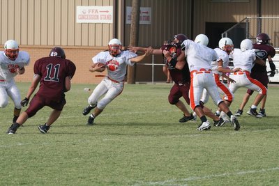 Image: Stiff-wing — This Avalon runner uses his wing to stiff-arm the defense.