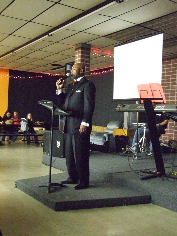 Image: Rev. Isaac — Rev. Isaac spoke for the crowd to ask for blessings on the service.