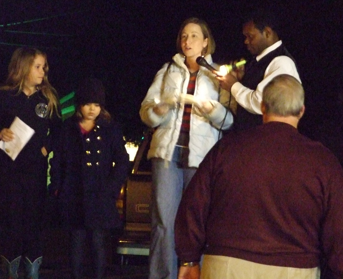 Image: The children sing — The children took the stage and sang for the audience as they lit the tree.