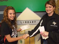 Image: Morgan receives $25.00 — Italy ISD Principal Tanya Parker congratulates artist Morgan Cockerham and hands her a check for $25.00 for winning 3rd place in the art poster contest.