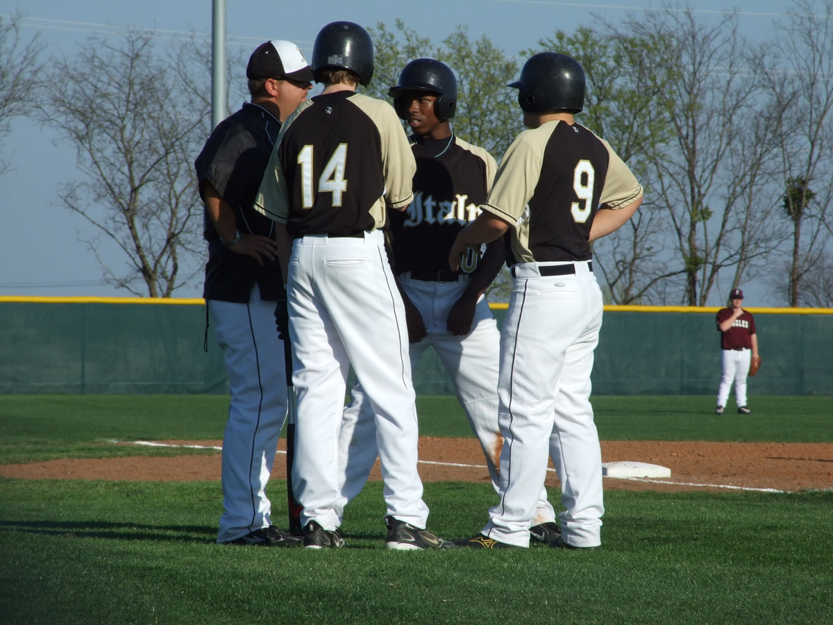 Image: Coach Gives Some Tips — Head Coach Matt Coker instructs Colton Campbell, Jasenio Anderson and Ethan Simon with some last minute plays.