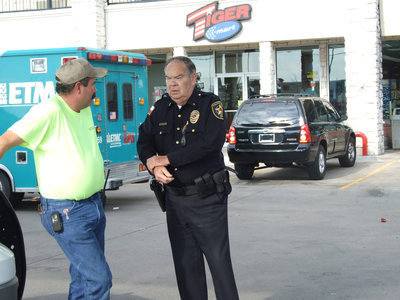 Image: That’s That — Chief C.V. Johns and Keith Helms discuss the events that had just unfolded in the Stuckey’s parking lot.