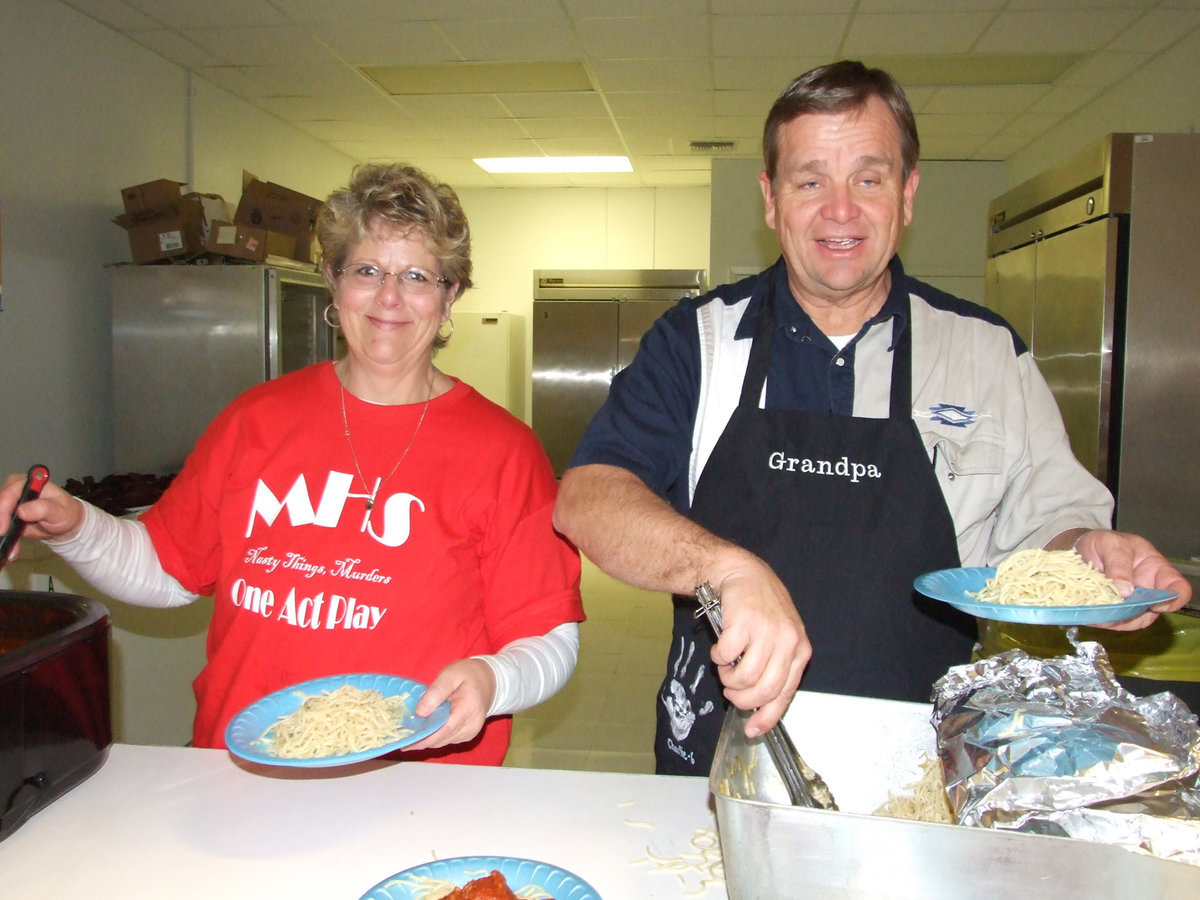 Image: Lets Eat — Cheryl Sessums (play director) and Steven Johnson serving up dinner.