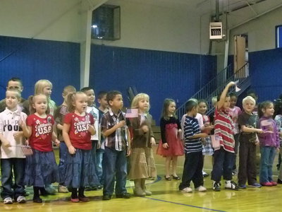 Image: Kindergarten &amp; First Graders — These cute students sang very enthusiastically, “When the Flag Goes By”.