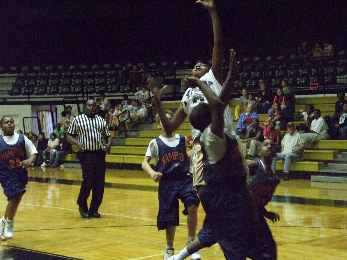 Image: Trey for Two — Italy’s #3 Trey Robertson goes up and over Hampton defenders for a score.