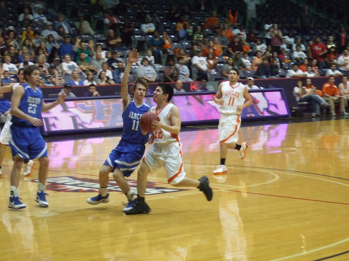 Image: Mungia Fights! — Senior #32 Rodney Mungia pushes the ball up the court to score.