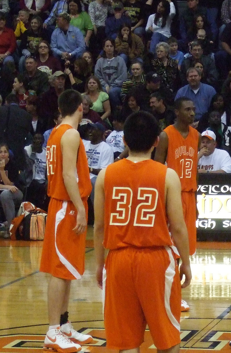 Image: 
    	#12   #32 — Crocker, Mungia and Hughes get ready for the tip-off in the Avalon vs. Forestburg game.
    