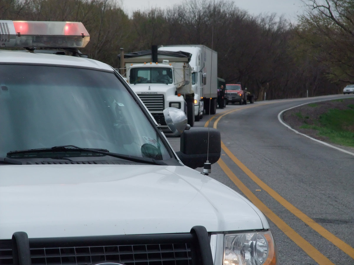 Image: Emergency vehicles block traffic — Italy Police Chief C.V. Johns stops traffic clearing room for AirEvac to land at the scene of a motorcycle crash on HWY 77.