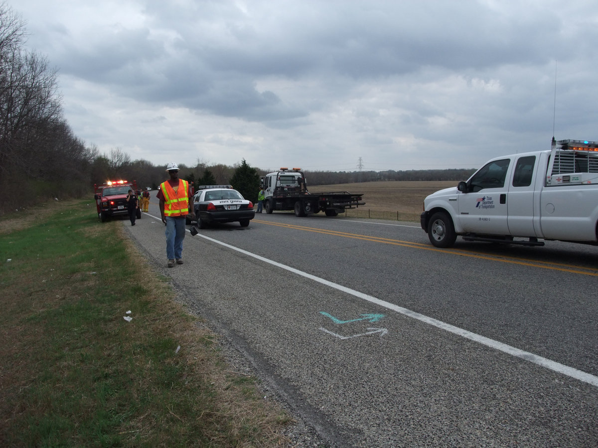 Image: Walking the scene — The Department of Transportation surveys the scene.