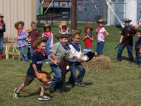 Image: And we’re off — The lil’ buckaroos scrambled down the corral to see which horse was faster.