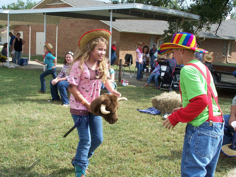 Image: Fernando, the bull — Jill Varner tries to hurry past Clay the Clown.