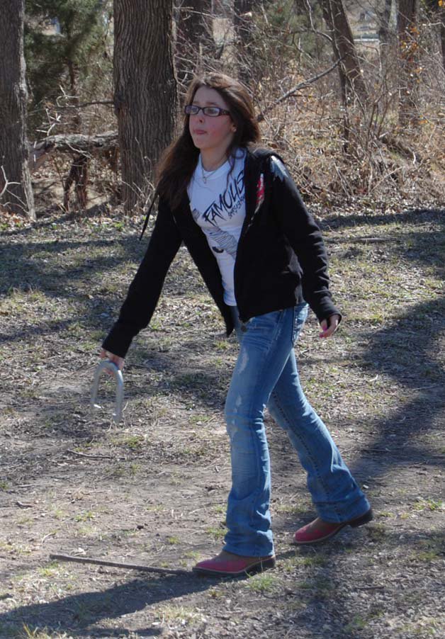 Image: Horse Shoes — Gabrielle Hearn of Italy tests her skills in the horse shoe tournament.