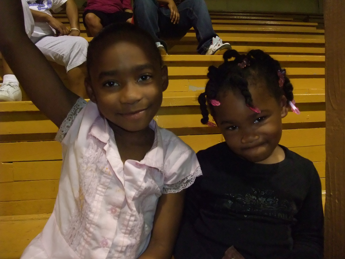 Image: Cuties in the crowd — These darlings are enjoying the action on the court.