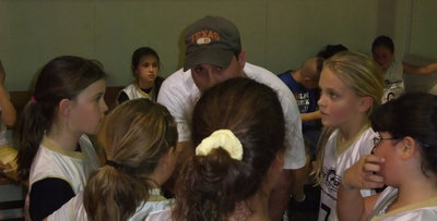 Image: Coach Holden — Coach Shawn Holden helps his girls get a handle on the moment.